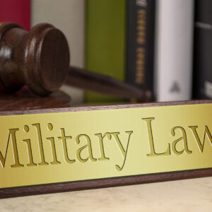 Image of a gavel and military law placard