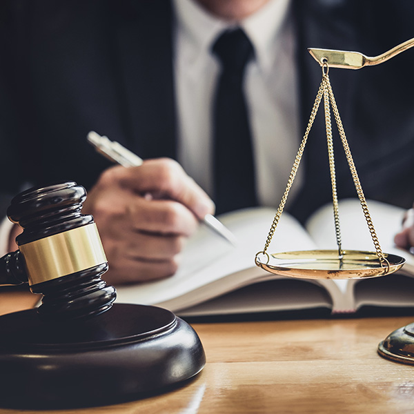 lawyer next to justice scales and gavel