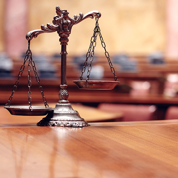 scales of justice on a desk in a courtroom