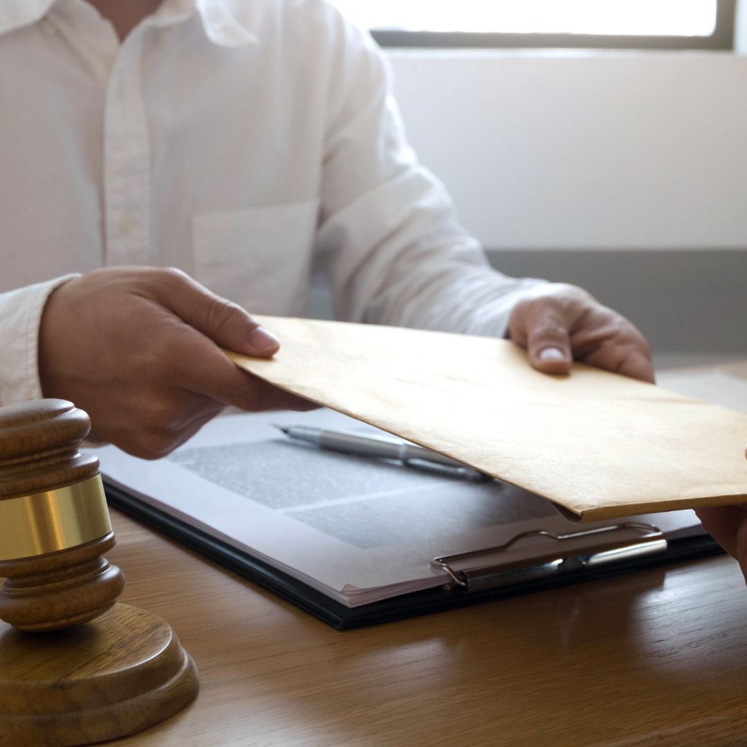 An organized stack of papers and files in a folder. 