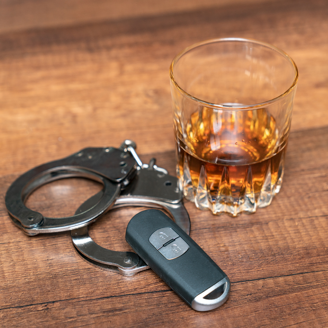An alcoholic drink, handcuffs, and keys